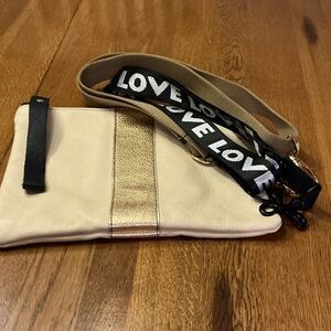 Woman’s Lynn Tallerico cream with/ gold stripe crossbody/Wristlet bag.Two straps